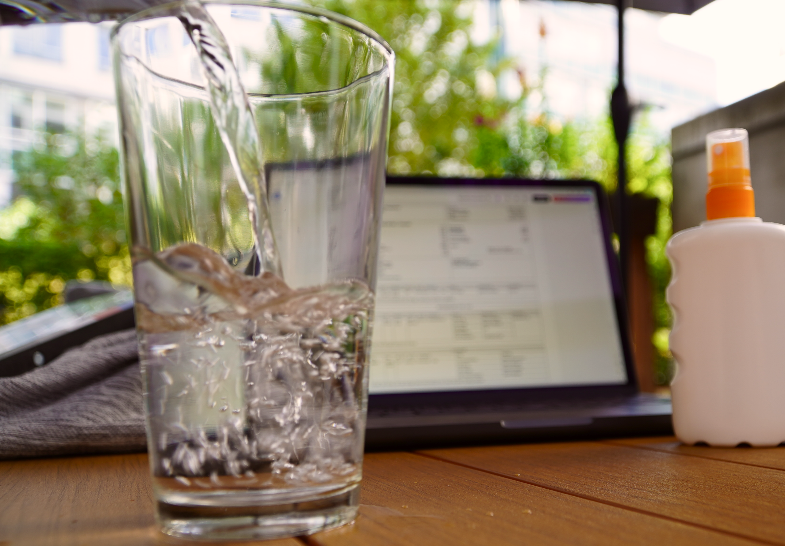 Behind-the-scenes detail on a summer production: water, sunscreen and a call sheet on set